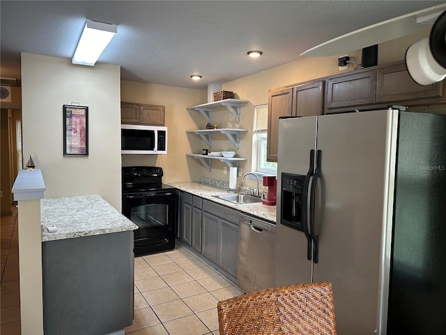 kitchen featuring sink, stainless steel appliances, and light tile patterned floors