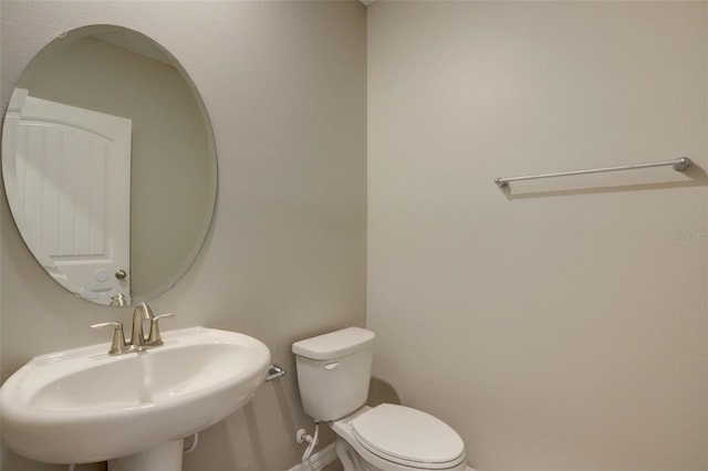 bathroom featuring toilet and sink