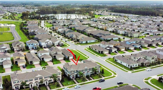 birds eye view of property with a water view