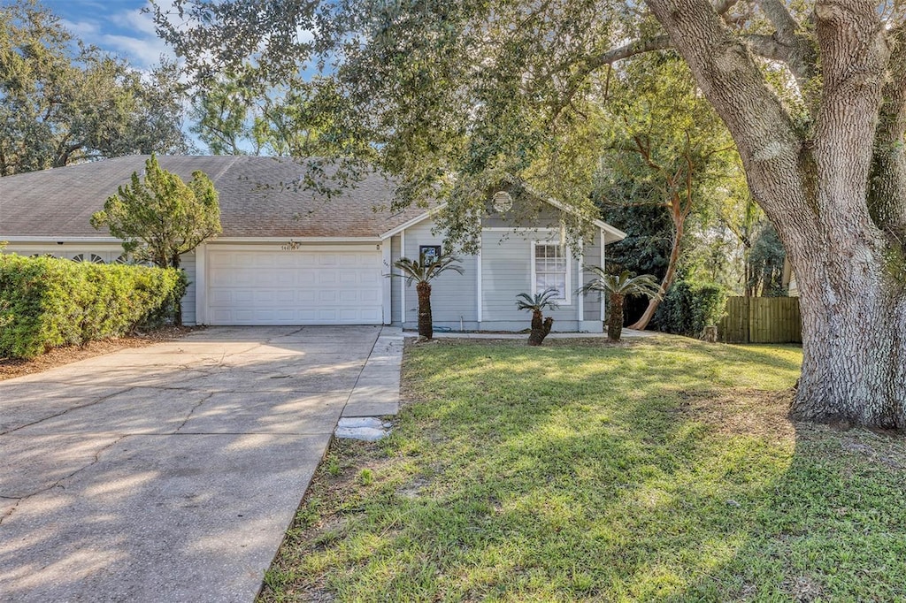 view of front of property featuring a front lawn and a garage