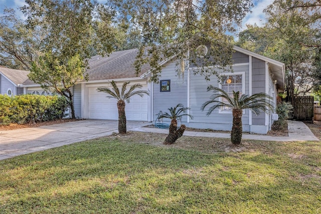 view of front of property featuring a garage and a front lawn