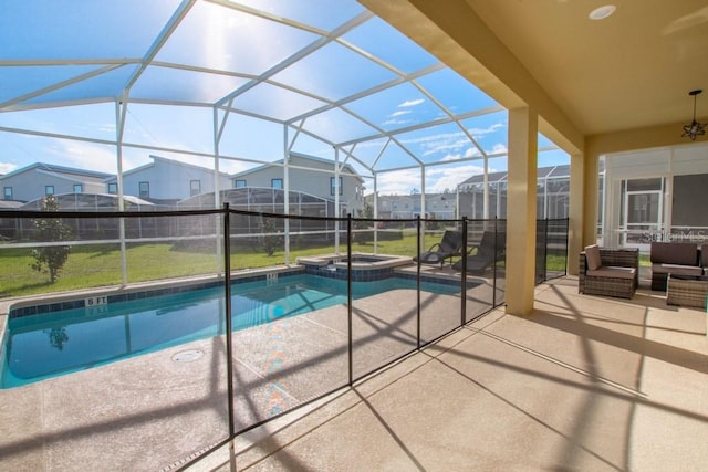 view of pool with a yard, a patio area, an in ground hot tub, and glass enclosure