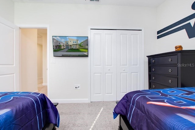 carpeted bedroom with a closet