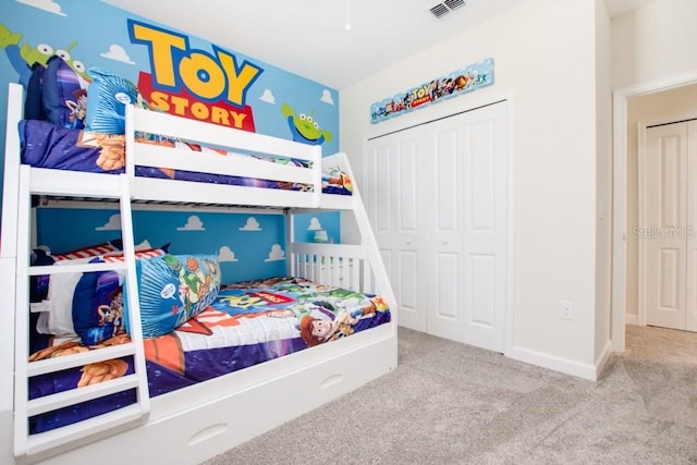 bedroom featuring a closet and light carpet