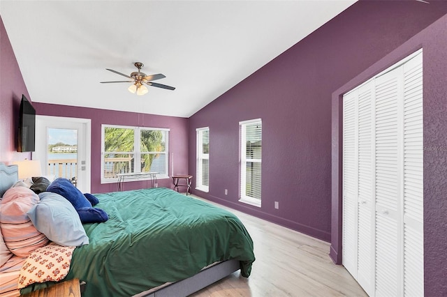 bedroom with ceiling fan, vaulted ceiling, and light wood-type flooring