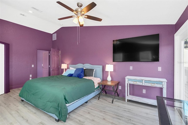 bedroom with lofted ceiling, light hardwood / wood-style floors, and ceiling fan