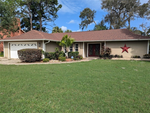 single story home featuring a front yard and a garage