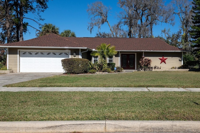 single story home with a garage and a front lawn