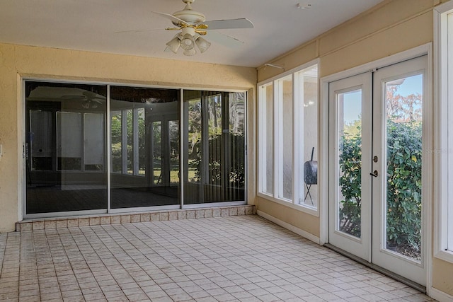 unfurnished sunroom with ceiling fan and french doors