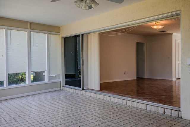 empty room featuring crown molding and ceiling fan