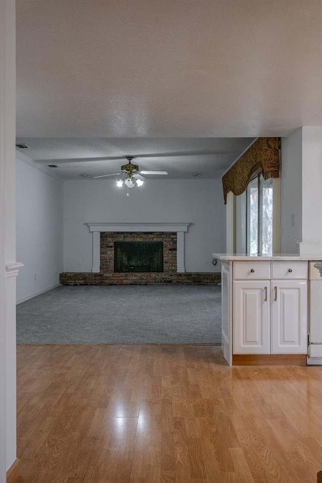 unfurnished living room featuring ceiling fan and light hardwood / wood-style floors