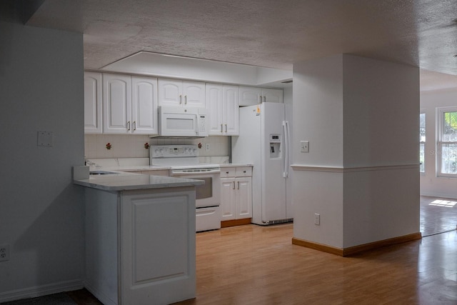 kitchen with sink, white cabinetry, light hardwood / wood-style flooring, white appliances, and decorative backsplash