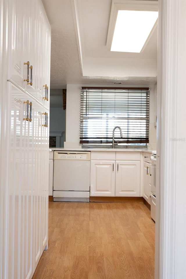 kitchen with white cabinetry, range, dishwasher, and light hardwood / wood-style flooring