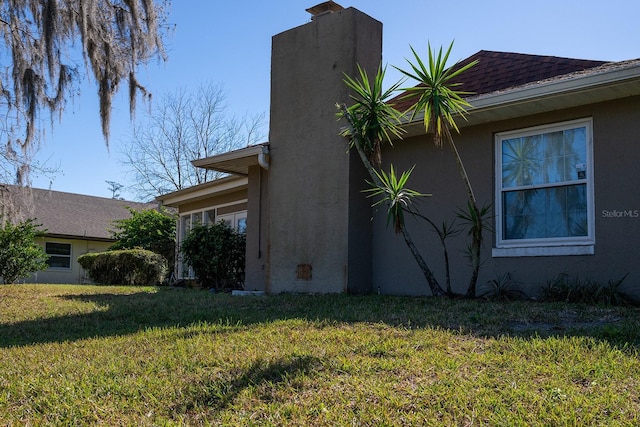 view of home's exterior with a yard