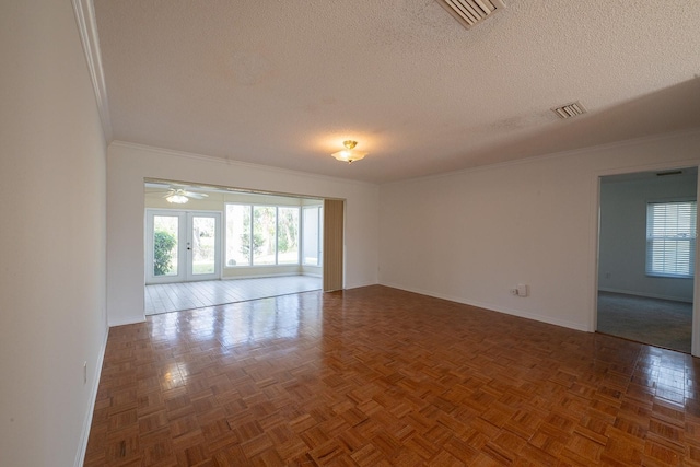 unfurnished room with ceiling fan, dark parquet flooring, ornamental molding, and a textured ceiling