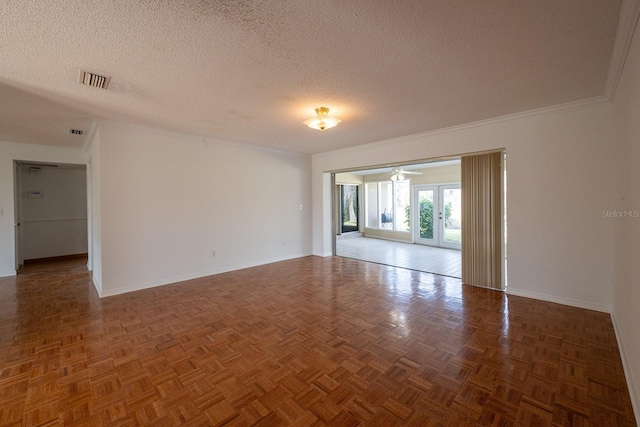 empty room with dark parquet flooring, french doors, and a textured ceiling