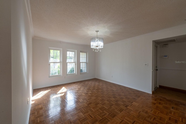 spare room with ornamental molding, dark parquet floors, a chandelier, and a textured ceiling