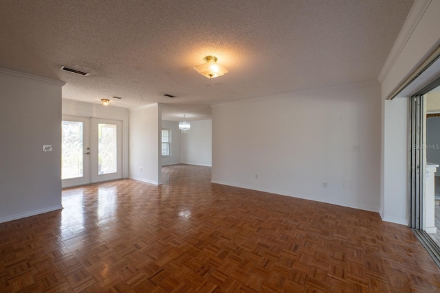 unfurnished room featuring parquet flooring, a textured ceiling, an inviting chandelier, and french doors