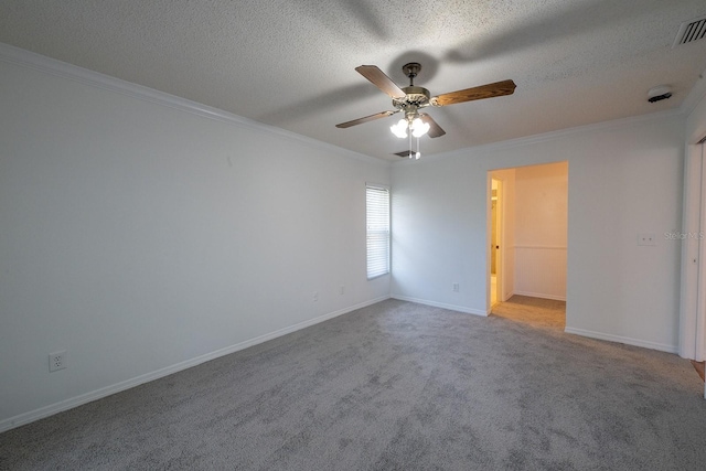 carpeted empty room with ceiling fan, crown molding, and a textured ceiling