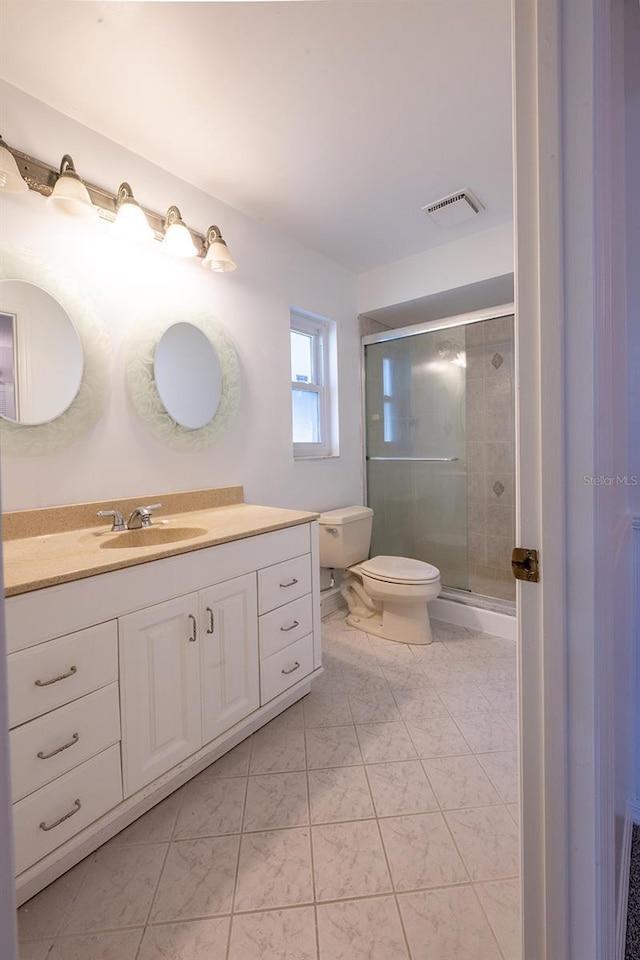 bathroom featuring walk in shower, vanity, and toilet