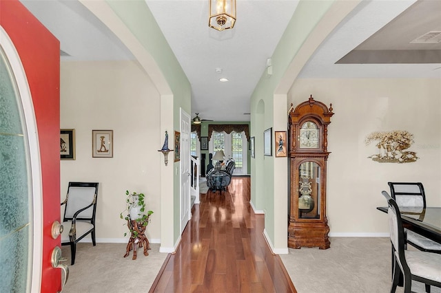 hallway with hardwood / wood-style flooring