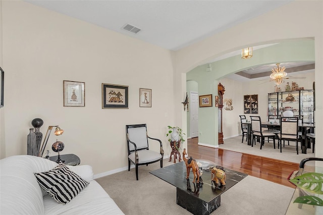 living room featuring a notable chandelier and wood-type flooring