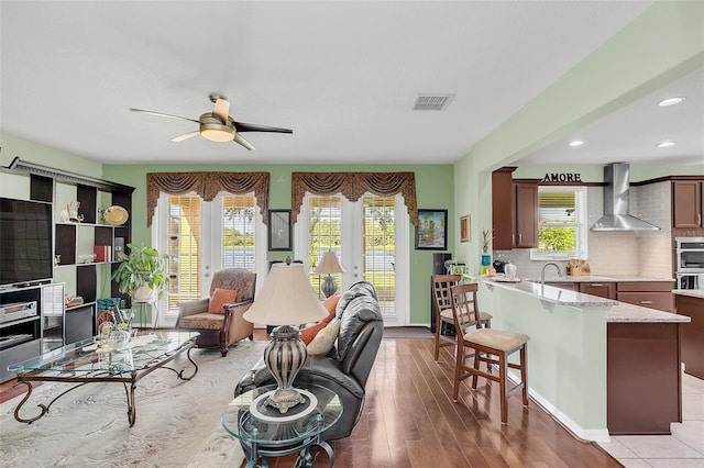 living room featuring light hardwood / wood-style flooring and ceiling fan