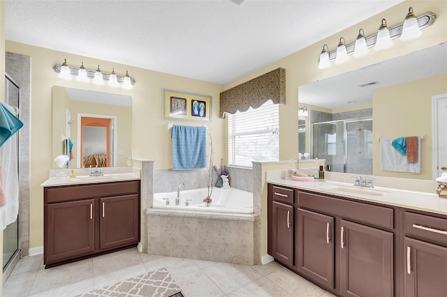 bathroom featuring vanity, a textured ceiling, separate shower and tub, and tile patterned flooring