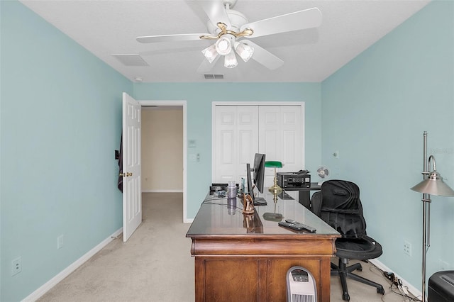 carpeted office with a textured ceiling and ceiling fan