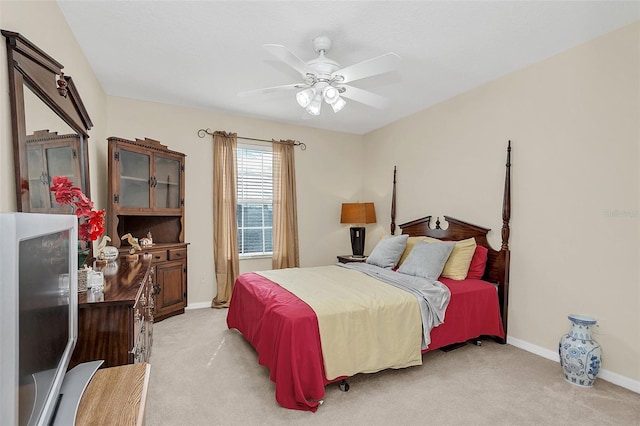 bedroom with ceiling fan and light colored carpet