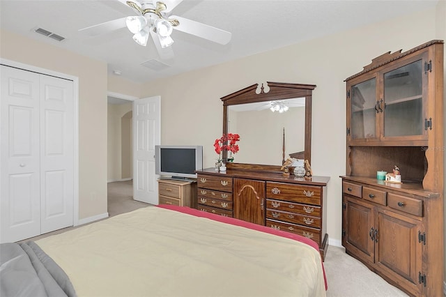 carpeted bedroom with a closet and ceiling fan