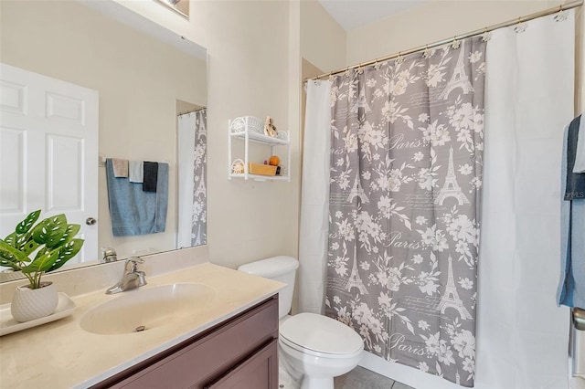 bathroom with vanity, a shower with curtain, toilet, and tile patterned floors