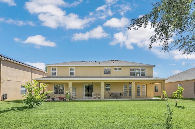 rear view of house featuring a yard and a patio area