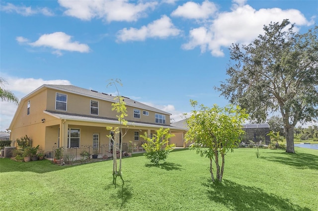 back of property featuring a lanai, a yard, central AC unit, and a porch