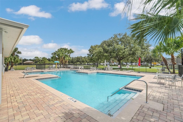 view of pool featuring a patio and a hot tub