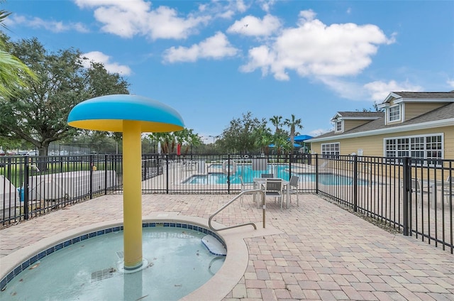 view of swimming pool with a hot tub and a patio area