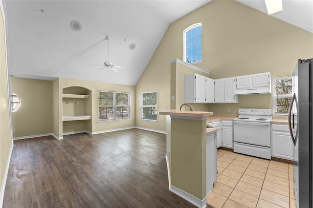 kitchen featuring white cabinetry, electric stove, light hardwood / wood-style floors, and stainless steel fridge