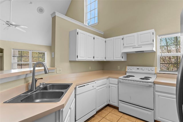 kitchen with white appliances, light countertops, under cabinet range hood, and a sink