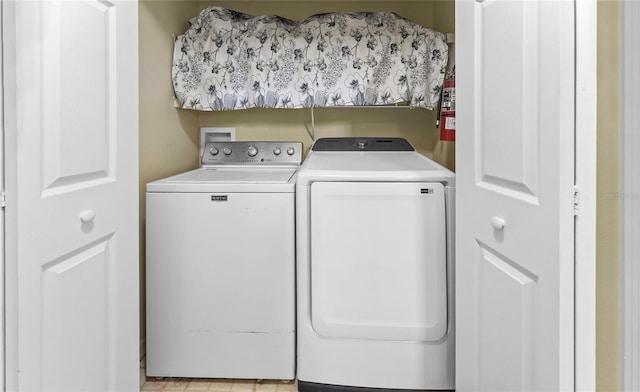 laundry area with laundry area and independent washer and dryer