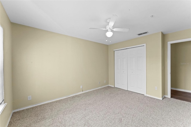 unfurnished bedroom featuring visible vents, ceiling fan, baseboards, carpet, and a closet