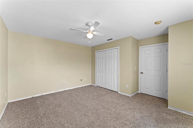 unfurnished bedroom featuring carpet, visible vents, a closet, and baseboards