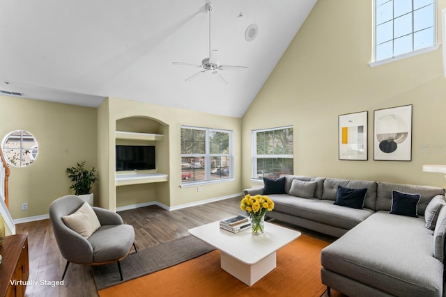 living room with visible vents, baseboards, wood finished floors, high vaulted ceiling, and a ceiling fan