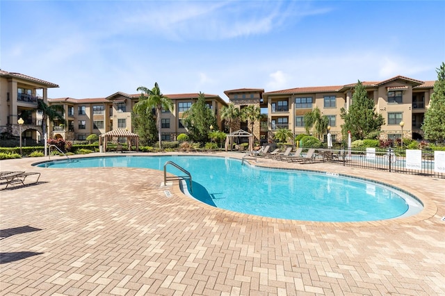 view of swimming pool with a gazebo and a patio