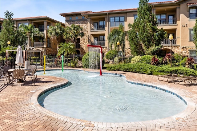 view of pool featuring a patio and pool water feature