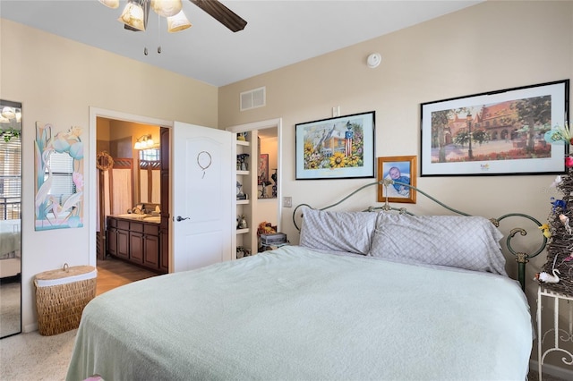 bedroom with ensuite bath and ceiling fan