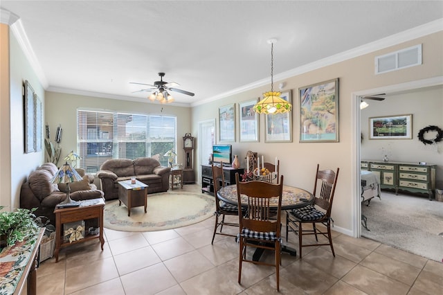 tiled dining space with crown molding and ceiling fan