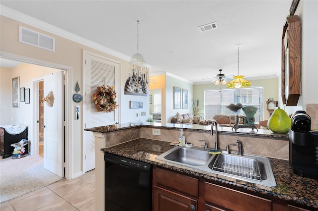 kitchen with dark stone counters, decorative light fixtures, black dishwasher, and sink