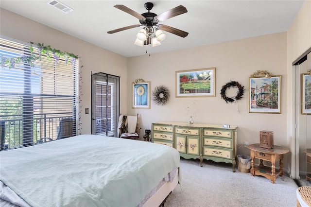 bedroom featuring access to outside, light colored carpet, and ceiling fan