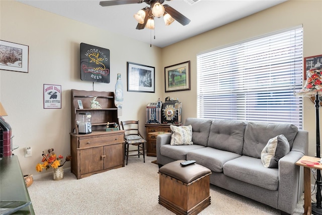 carpeted living room with ceiling fan