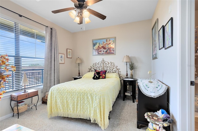 bedroom with ceiling fan and multiple windows